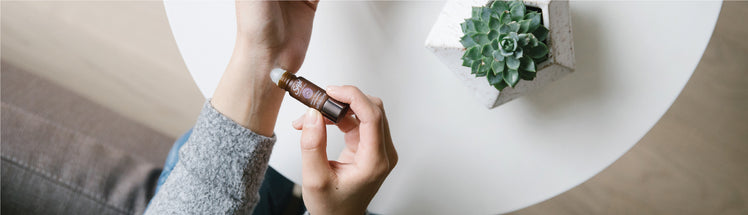  A person applying stress release onto their wrist pulse point