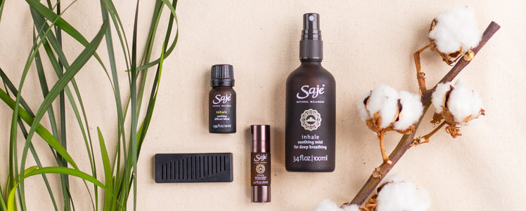 Saje Inhale collection placed with greenery and myrrh