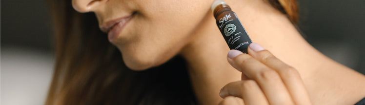 A person applying energy roll-on to their neck