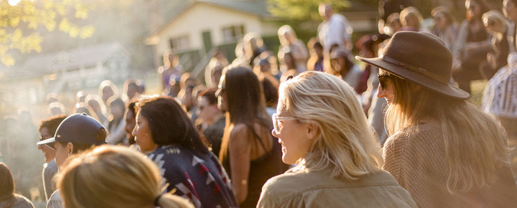 A picture of a group of people laughing outside