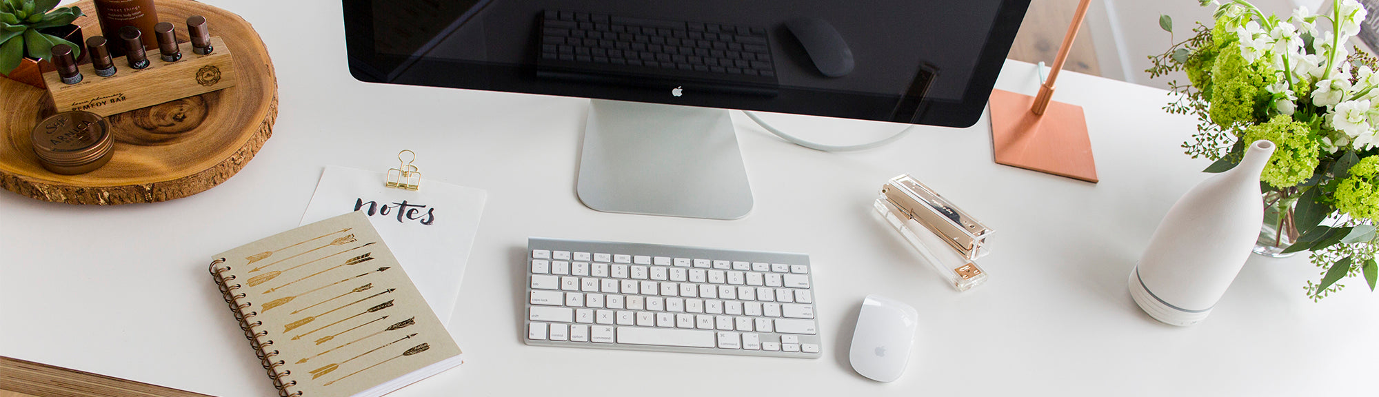 Computer placed with keyboard, plant, aroma om diffuser, and diffuser blends