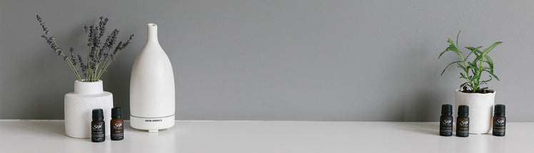 Aroma Om diffuser placed with Saje diffuser blends