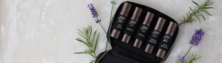 Saje Pocket Farmacy Physical Edition with a black case and lavender sprigs