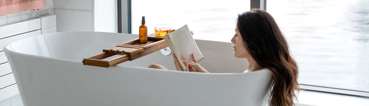 A person in the bathtub reading her journal