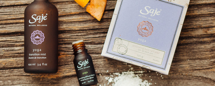 Yoga mist, yoga diffuser blend and yoga bath salt soak against a wooden background