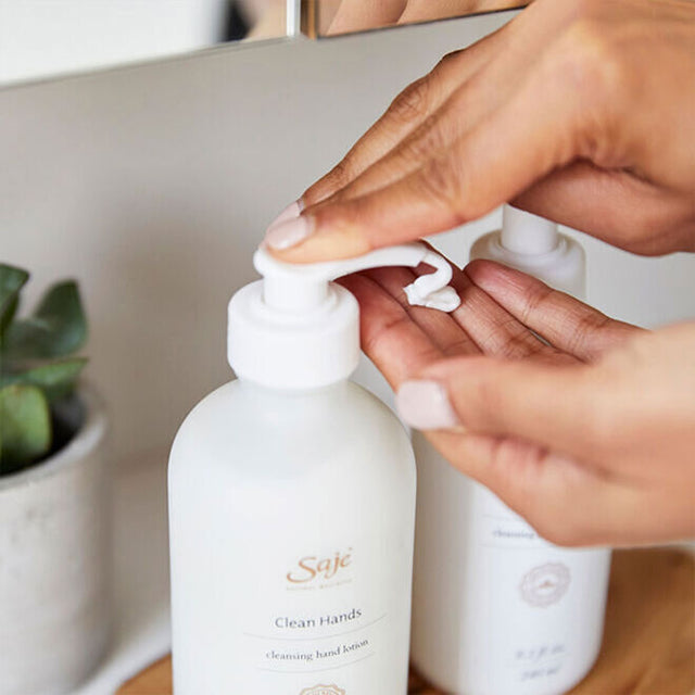 a pair of hand dispensing the Clean Hands lotion into the other