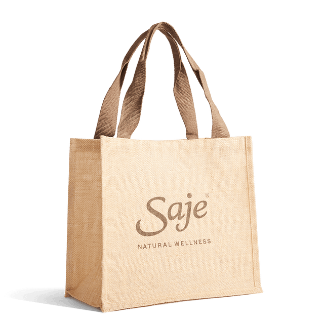 Large brown jute tote bag with handles and Saje Natural Wellness printed on the front