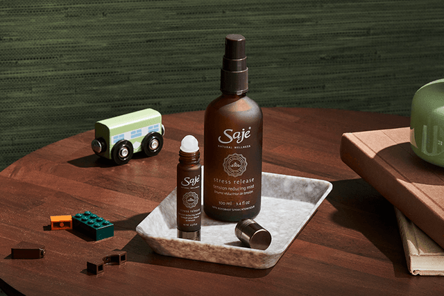 Person spraying Stress Release mist in front of a bright window