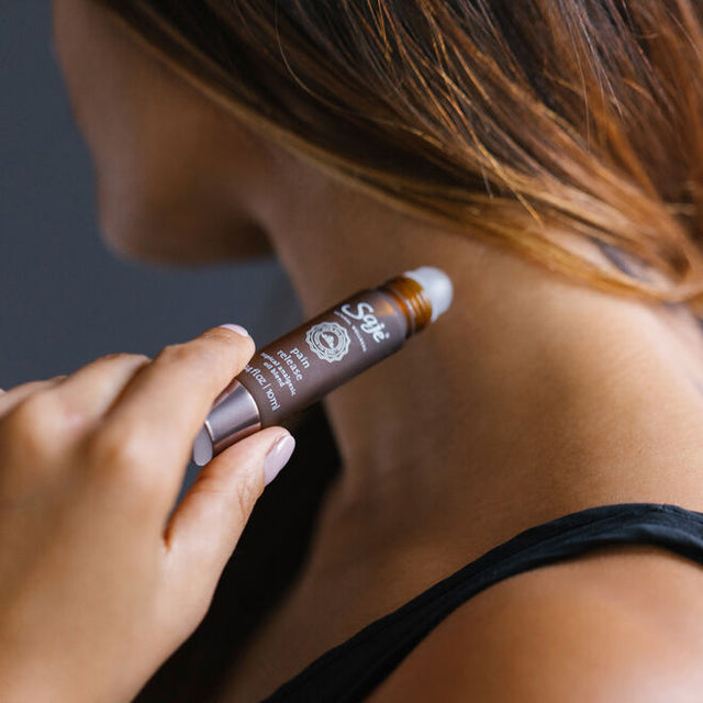 Pain release roll-on being applied to pulse point