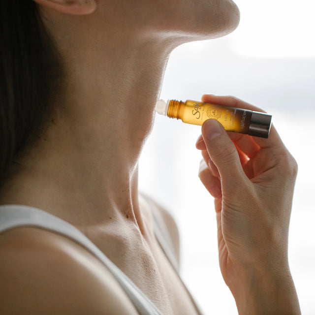 Woman applying Solace onto her neck