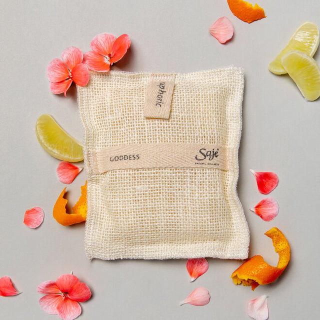 Goddess Jute & Joy Wash Pad with geranium, lemon slices and orange peels around it 