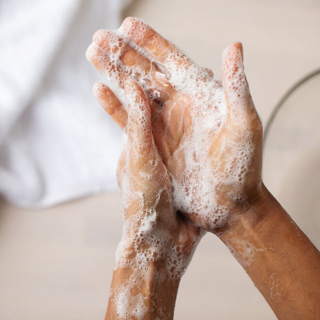 A person washing their hands with Lavender and Friends foaming hand soap 