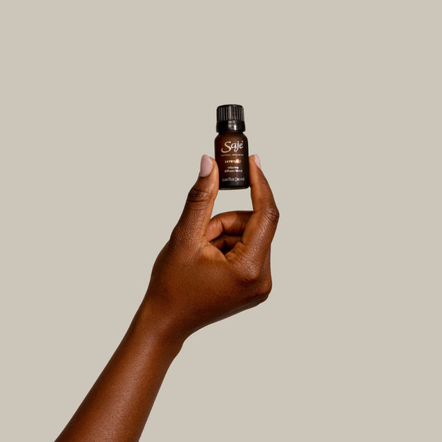 Serenity 0.34 fl oz diffuser blend with cap on in a hand