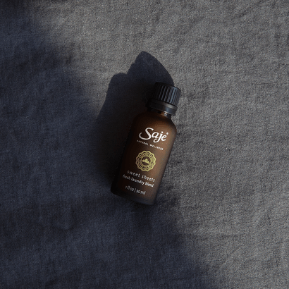 Sweet Sheets Fresh Laundry Diffuser Blend placed on top of bedding 